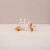 Difrax Crown Teething Ring in pink and wood, featuring a crown design and textured surfaces for soothing gums.