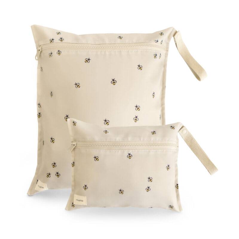 Mushie Water Resistant Wet Bag in Bees design, featuring a cream background with small bee patterns, includes two sizes.