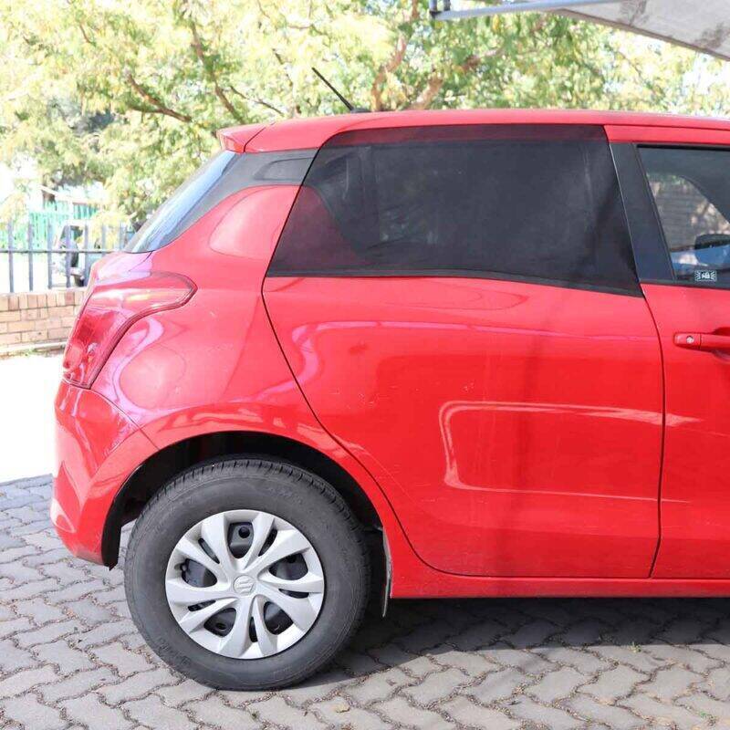 Snuggletime Curved Window Shades on a red car, providing privacy and sun protection with a sleek design.