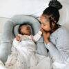 Snuggletime Bamboo Muslin Receiver in blue star, featuring a baby and mother sharing a tender moment in a cozy setting.