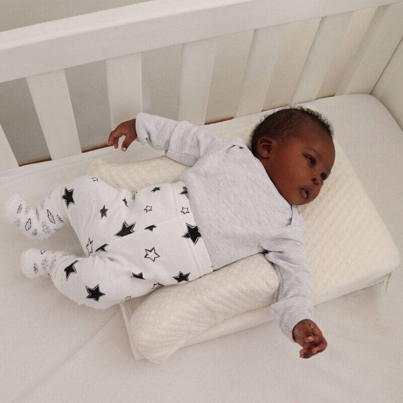 Snuggletime Bamboo Inclined to Sleep, featuring a baby resting comfortably on a soft incline in a crib.