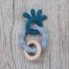 Back To Nature Teether Ring in blue and gray with a wooden ring, featuring textured surfaces for sensory play.