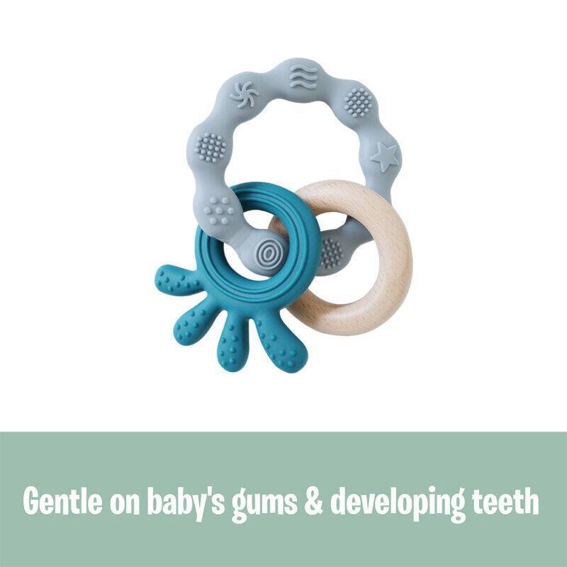 Back To Nature Teether Ring in blue and pink, featuring textured surfaces and a wooden ring for soothing gums.