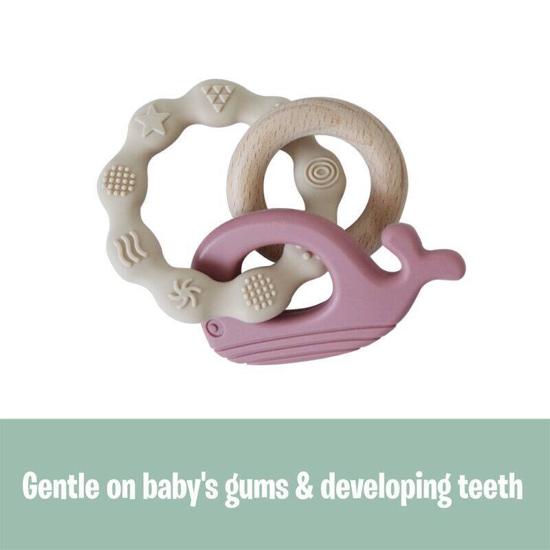 Back To Nature Teether Ring in blue and pink with a whale design, featuring textured surfaces for soothing gums.