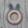 Back To Nature Teether Ring in green and pink with a rabbit design, featuring a wooden center and textured ears.