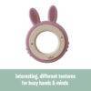 Back To Nature Rabbit Teether Ring in pink and green, featuring textured surfaces for sensory exploration.