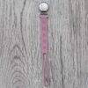 Back To Nature Silicone Pacifier Clip in pink with flower designs, featuring a sturdy metal clip for secure attachment.