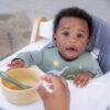 Back to Nature 5pc Character Silicone Feeding Set in Dinosaur design, featuring a child in a high chair with a bowl and