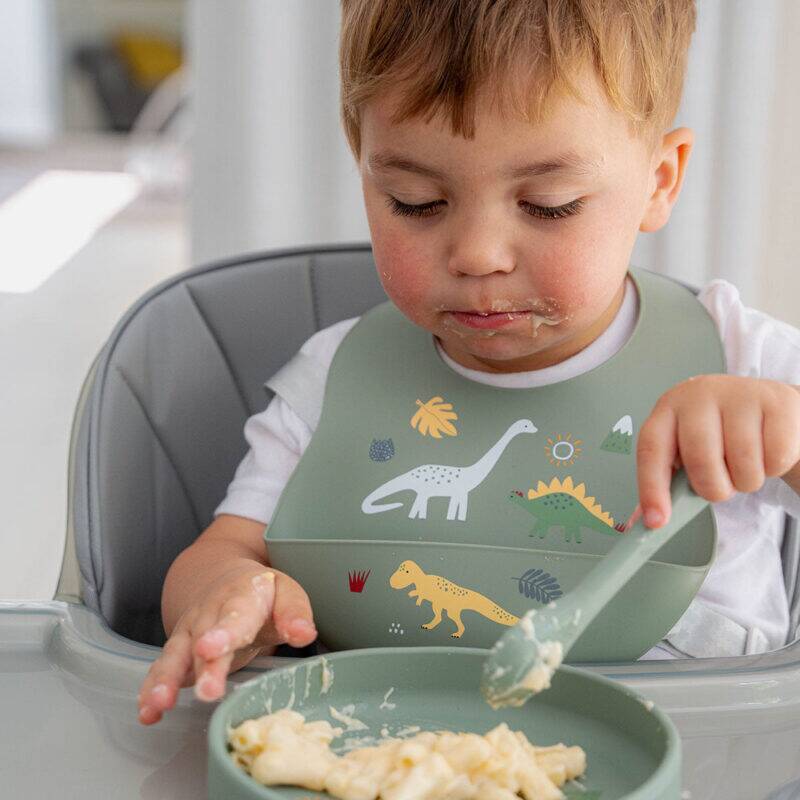 Back to Nature 5pc Character Silicone Feeding Set in Dinosaur design, featuring a child eating with a bib and bowl.