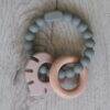Back to Nature Silicone Teether Leaf in muted green and pink, featuring a wooden ring for added texture and grip.