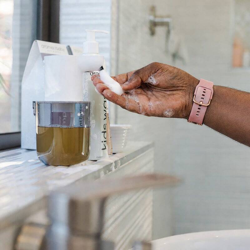 BabySafe Touchless Foam Soap Dispenser dispensing foam soap into a hand, set on a bathroom countertop with a modern design.