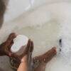 BabySafe Touchless Foam Soap Dispenser in use, held by a child in a bubbly bath setting, promoting hygiene and fun.