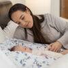 Snuggletime Deluxe Comfort Pod with Activity Arch in a cozy setting, with a mother interacting with her baby.