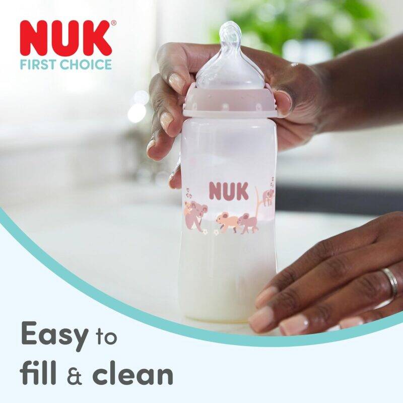 Nuk First Choice 150ml bottle in Koala and Whale style, held in a hand, showcasing easy filling and cleaning features.
