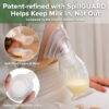 Haakaa Gen. 2+ Silicone Manual Breast Pump with SpillGUARD Insert, 100ml, showing detail of the pump in use with milk.