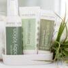 Aromababy barrier cream displayed with baby lotion and healing balm in a white dish, set against a soft, neutral background.