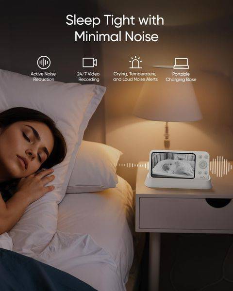 Eufy E21 Wireless 4K Portable Smart Baby Monitor on a nightstand, showing a sleeping woman and monitor displaying baby