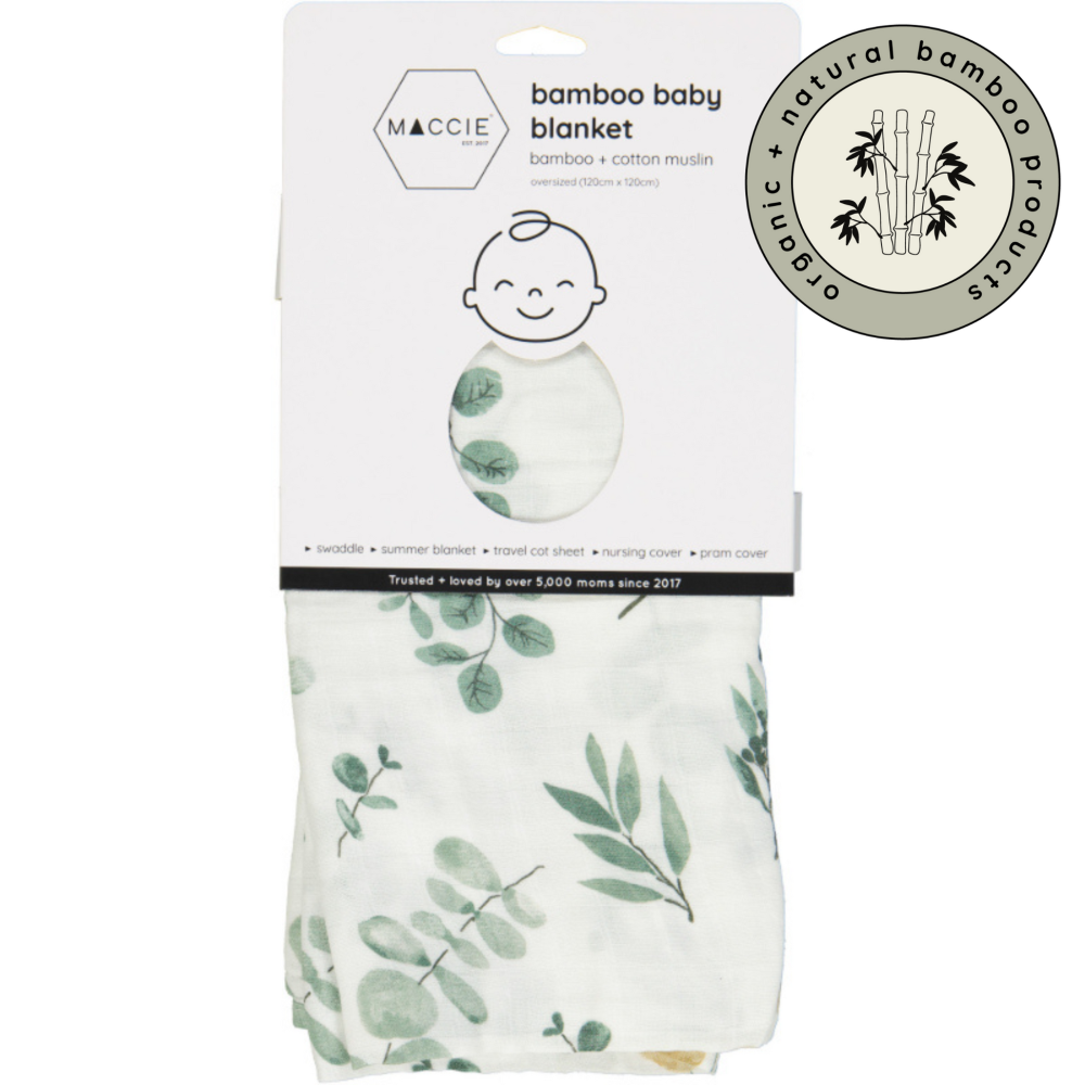 MACCIE bamboo muslin baby blanket in African Adventure design featuring green leaf patterns on a white background.